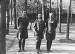 Reichsfuehrer-SS Heinrich Himmler strolls with two other SS officials [probably at Wolfsschanze (Wolf's Lair), Hitler's field headquarters in Rastenburg, East Prussia].