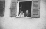 Heinrich and Margarete Himmler look out the window of their home on their chicken farm in Waldtrudering near Munich.