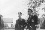 Reichsfuehrer-SS Heinrich Himmler stands outside with Karl Wolff.