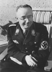 Portrait of Reichsfuehrer-SS Heinrich Himmler seated on a lawn chair.