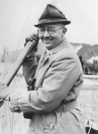 Heinrich Himmler poses in a boat holding an oar.