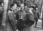 Reichsfuehrer-SS Heinrich Himmler converses with two German officers.
