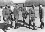 Reichsfuehrer-SS Heinrich Himmler (second from right) confers with Waffen-SS Armored Division Wiking chief, SS-Brigadefuehrer and Major General Felix Steiner (right) during a visit to a village.