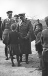Reichsfuehrer-SS Heinrich Himmler speaks to a young girl.