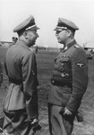 Reichsfuehrer-SS Heinrich Himmler (left) confers with SS and Police Leader Hans Adolf Pruetzmann (right) [probably during Himmler's visit to the Waffen SS Armored Division Wiking].