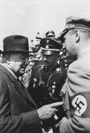 Heinrich Himmler (center) with Constantin Freiherr von Neurath (left) and the man on the right has been identified as either Fritz Wiedemann or Rudolf Hess at a Reichsparteitag (Reich Party Day) rally in Nuremberg.