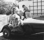 Three young German children ride in a toy car. 

Written on the side of the car is, "Brothers and sisters Baldur von Schirach."  Some of these children may be those of Baldur von Schirach.