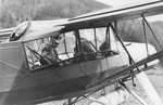 Reichsfuehrer-SS Heinrich Himmler riding as a passenger in an airplane.