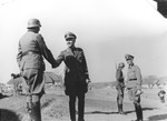 Reichsfuehrer-SS Heinrich Himmler shakes hands with a member of the Waffen-SS Armored Division Wiking during an official visit.