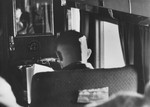 Reichsfuehrer-SS Heinrich Himmler reading in a private compartment of a plane or train.