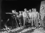 American officers speak with a medical officer while on an inspection of the ruins of the Boelke Kaserne in the Nordhausen concentration camp.