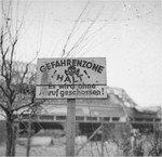 View of a sign on the perimeter of the compound in the Nordhausen concentration camp warning that persons who enter the "Danger Zone" will be shot without warning.