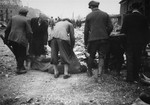 German civilians collect the corpses of prisoners killed in the Nordhausen concentration camp for burial in a mass grave.