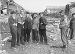 An American soldier speaks outside with five survivors in the Nordhausen concentration camp.