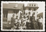 The kitchen staff of the Morgins family camp poses outside the main building.