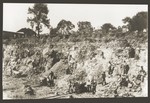 Jews at forced labor working on a hillside beneath the Jewish cemetery in Kamionka.