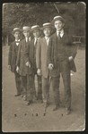 Szmuel Liwer (right) and four friends pose in fancy dress for a humorous photo to send back to their friends in Bedzin.