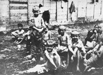 Emaciated Serbian children from the Kozara region sit outside in the Stara Gradiska concentration camp.