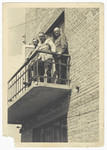 Three German officers stand on a balcony of a building in Russia during the German invasion of 1941.