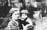 A Dutch woman poses with a Jewish toddler who has been placed in her care by the underground NV group to protect him from deportation