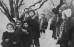 A little Jewish girl living in hiding in Warsaw, goes sledding with a group of Polish children.