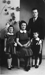 Studio portrait of Israel and Chana Fajga Pesses with their children, Berthe and Albert.