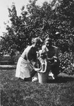 Siny Natkiel plays with a bucket in a garden along with her rescuers, Dr.