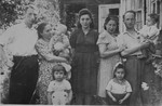 Jewish DP couples pose with their young children outside a home in Minsk.