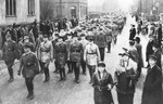 Local residents line the streets during an SA march in an unidentified German town.