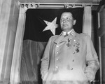 Reich Air Marshal Hermann Goering poses in front of the flag of the U.S.