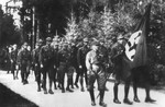 Members of the SA march in a funeral procession at a cemetery in Munich.