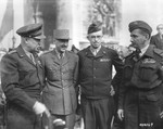 General Dwight D. Eisenhower confers with ranking French, British amd American officers at the Arc de Triomphe.