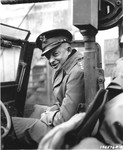 Portrait of General Dwight D. Eisenhower sitting in a jeep, ready to begin a tour of the front.