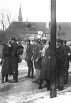 German police [Schutzpolizei] who are posted at the Berlin city line search SA men for weapons before allowing them to proceed to a rally in the capital.
