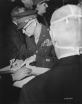 General Dwight D. Eisenhower signs the register at the tomb of the unknown soldier after a ceremony at the Arc de Triomphe, in which he was presented the Medal of Liberation by General Charles de Gaulle.