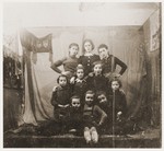 Group portrait of Jewish children in front of a stage set at a Purim celebration in the Zabno ghetto.