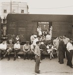 A group of Jewish DPs traveling along the Bricha route to the American Zone of Germany, board a box car at the Vienna railroad station.