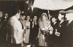 American military chaplain Rabbi Lifschitz officiates at the wedding of two members of the Bricha organization held at Frankgasse 2..