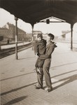 Shmulik Matzner, holding a child, waits at the Vienna railroad station for a train to take him on the next leg of his journey along the Bricha route to the American Zone of Germany.