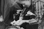 A Bergen-Belsen survivor washes her hands after her liberation.