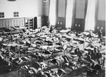 Bergen-Belsen survivors are treated in an improvised hospital set up with hundreds of beds in the Rundhaus, the former headquarters of the German Army in Bergen-Belsen.