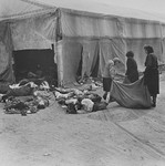 Female survivors in Bergen-Belsen remove corpses for burial.