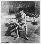 Close-up portrait of an emaciated survivor of the Ebensee concentration camp.