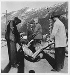 Austrian civilians remove corpses for burial after the liberation of the Ebensee concentration camp.