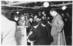 Men and women file past a table to vote in elections in the Zeilsheim displaced persons' camp.