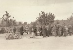 [Probably, an SD officer walking among Polish and Jewish civilians interned in a temporary holding center.]

These prisoners may be what the Germans called "Wehrfaehige", or persons capable of carrying arms, who were summarily interned during and immediately after the Polish campaign as a security measure.