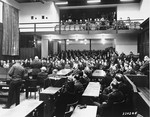 Captain Henry Gereke, a U.S. Army chaplain, reads a short sermon to the audience during a Thanksgiving Day service at the International Military Tribunal trial of war criminals at Nuremberg.
