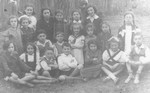 Group portrait of Jewish children from the Tarbut school in Ostrow Mazowiecka on an outing in the woods.