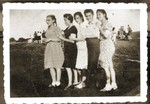 Five young women in the Bedzin ghetto pose in a line.