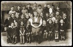 Group portrait of the pupils and teacher of a first grade class in Lodz.